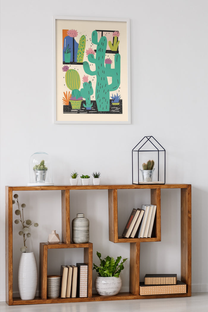 Colorful cactus artwork poster on wall above wooden bookshelf with plants and books in home interior