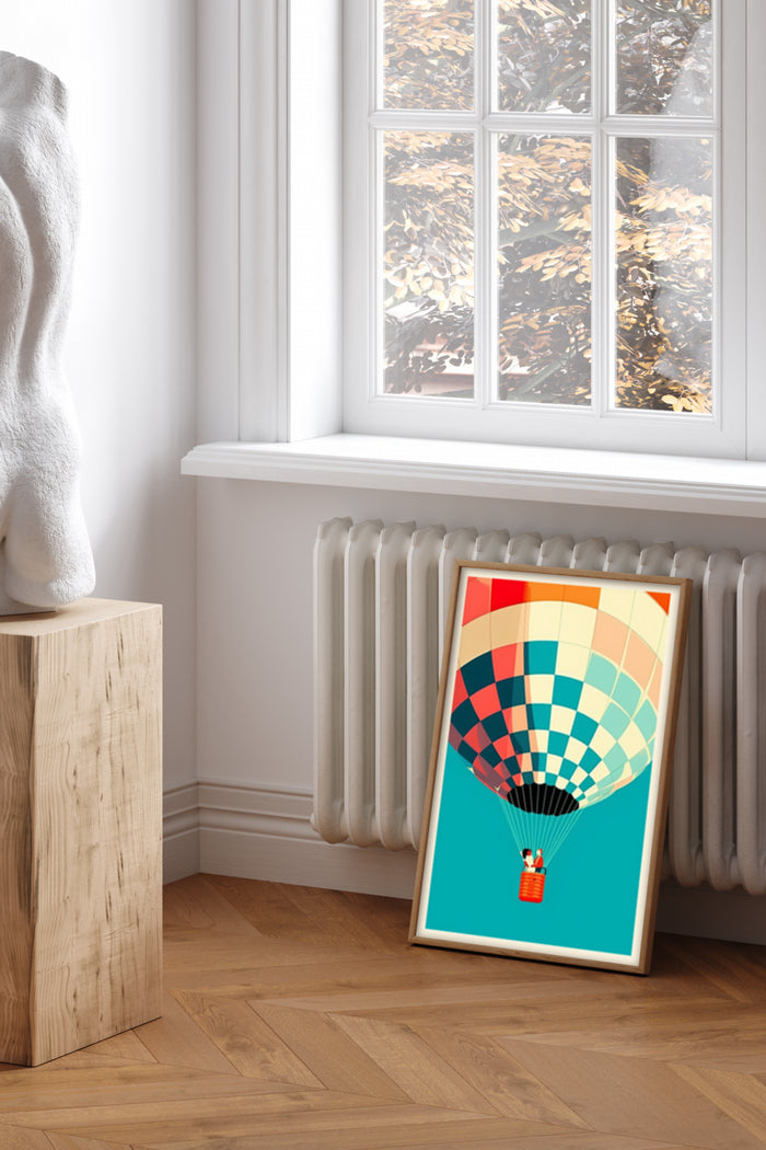 Colorful geometric pattern hot air balloon poster leaning against a wall beside a window