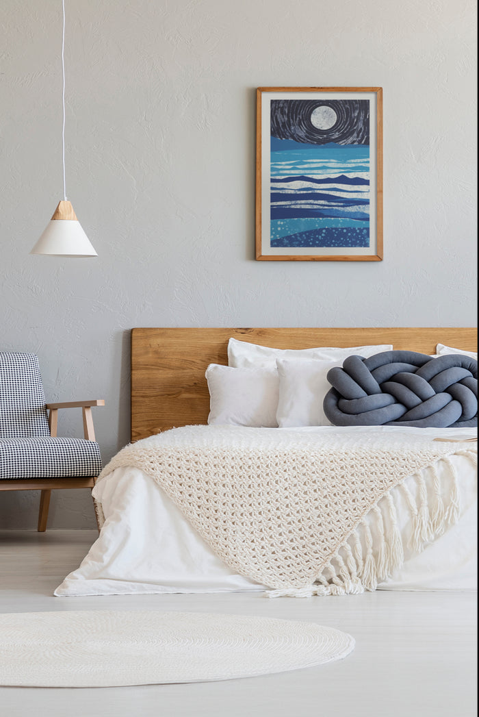 Modern bedroom with cozy white bedding, stylish chair, and sea-inspired artwork with moon hanging on the wall