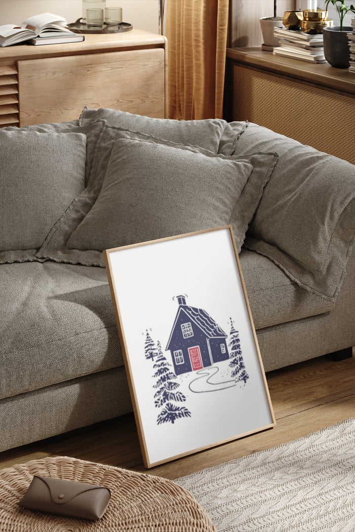 Cozy blue house illustration poster with pine trees displayed in a modern living room setting