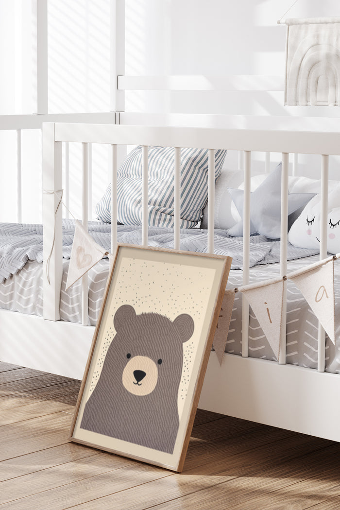 Cute illustrated bear poster leaning against a crib in a modern nursery room