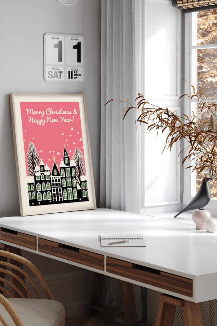 Merry Christmas and Happy New Year poster with snowy houses illustration on modern home office desk