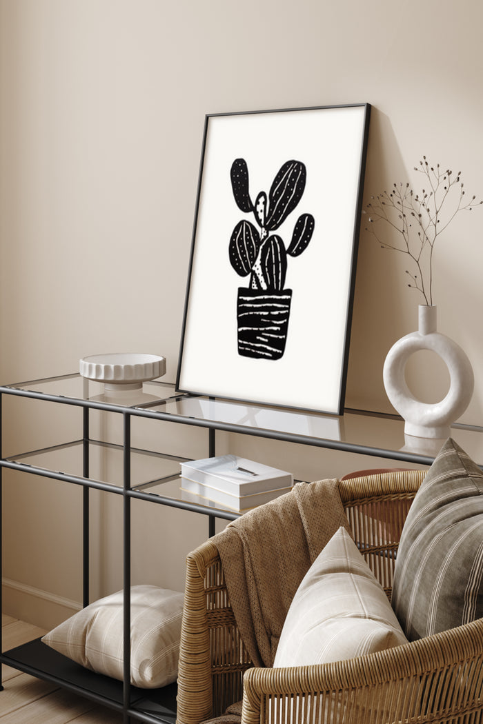 Minimalist black and white cactus illustration poster in a modern living room setting