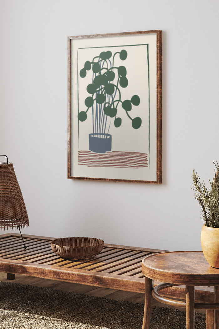 Minimalist green plant artwork in a wooden frame on a white wall above a wooden bench