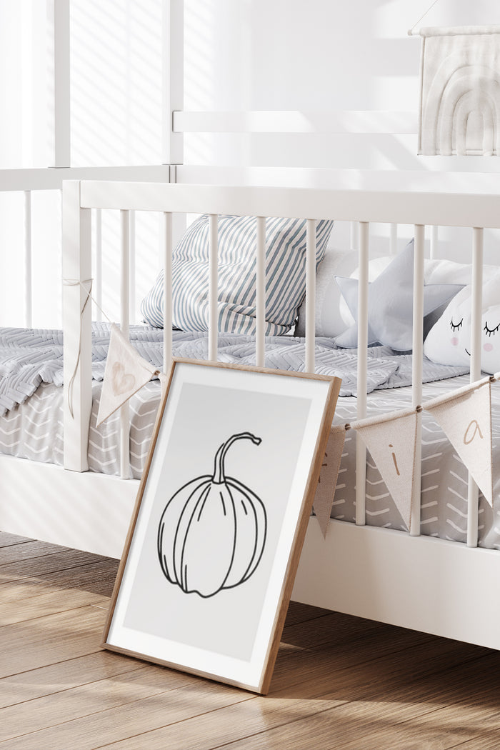 Minimalist black and white pumpkin drawing in a stylish frame placed in a modern nursery room