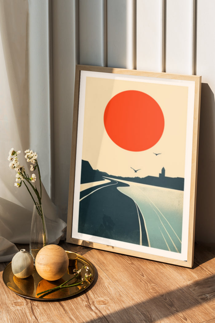 Minimalist sunset poster art featuring a winding road, silhouette of birds, and red sun in a stylish interior setting