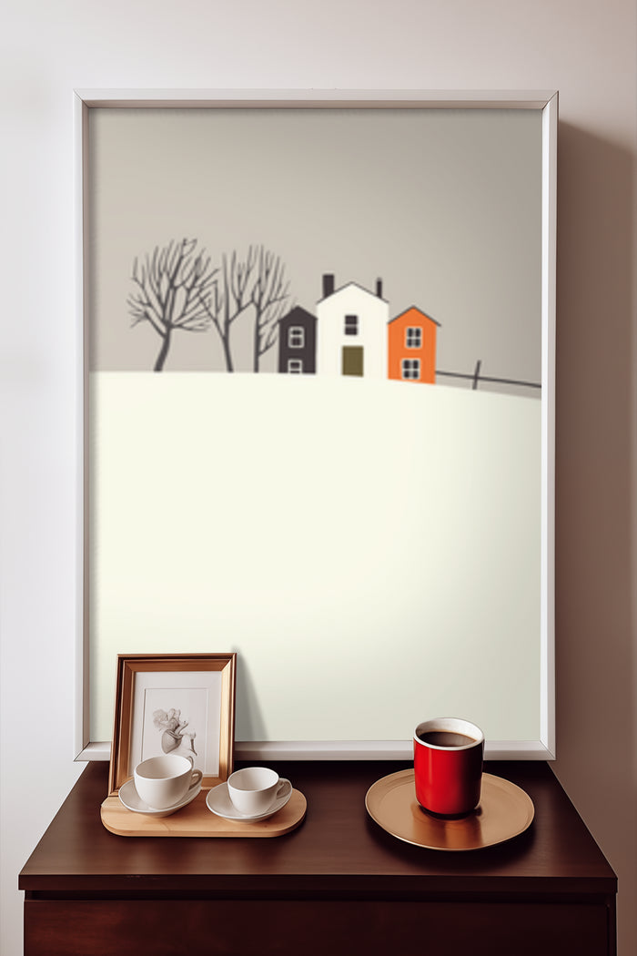 Minimalist winter landscape art poster featuring stylized houses and bare trees on a framed wall display with coffee cups
