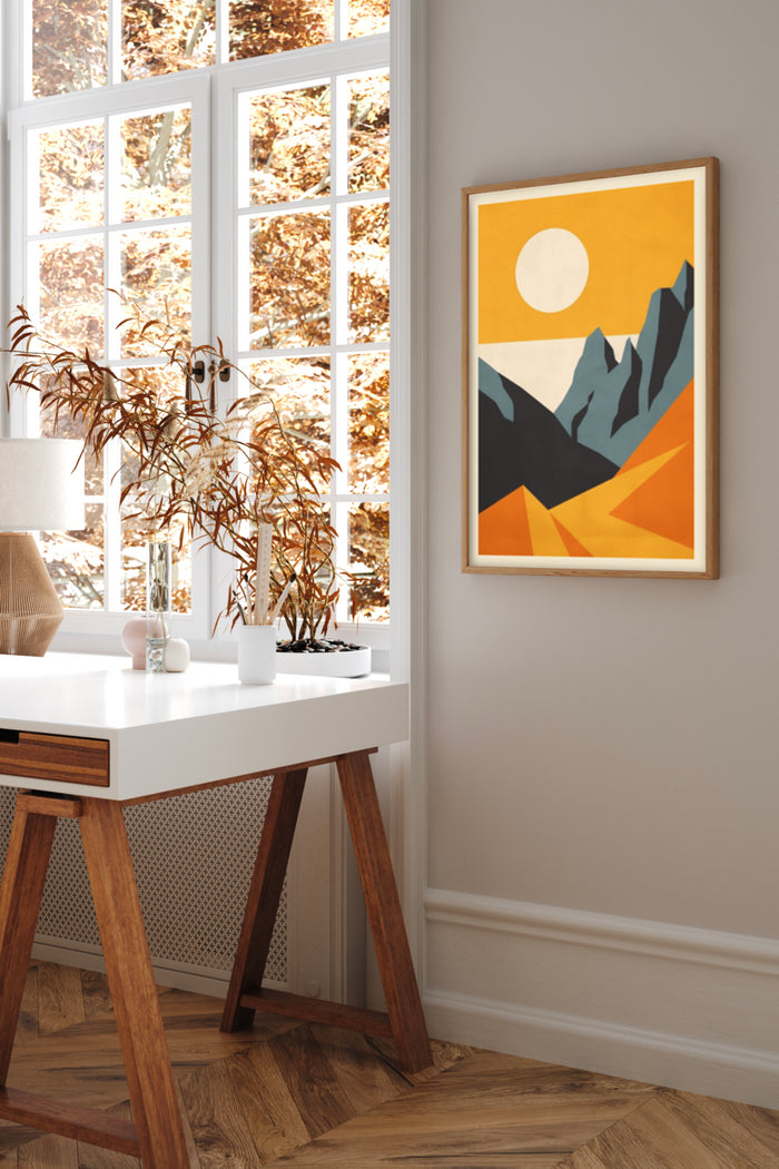 Modern abstract mountain landscape poster art with orange and blue tones in a stylish home office interior