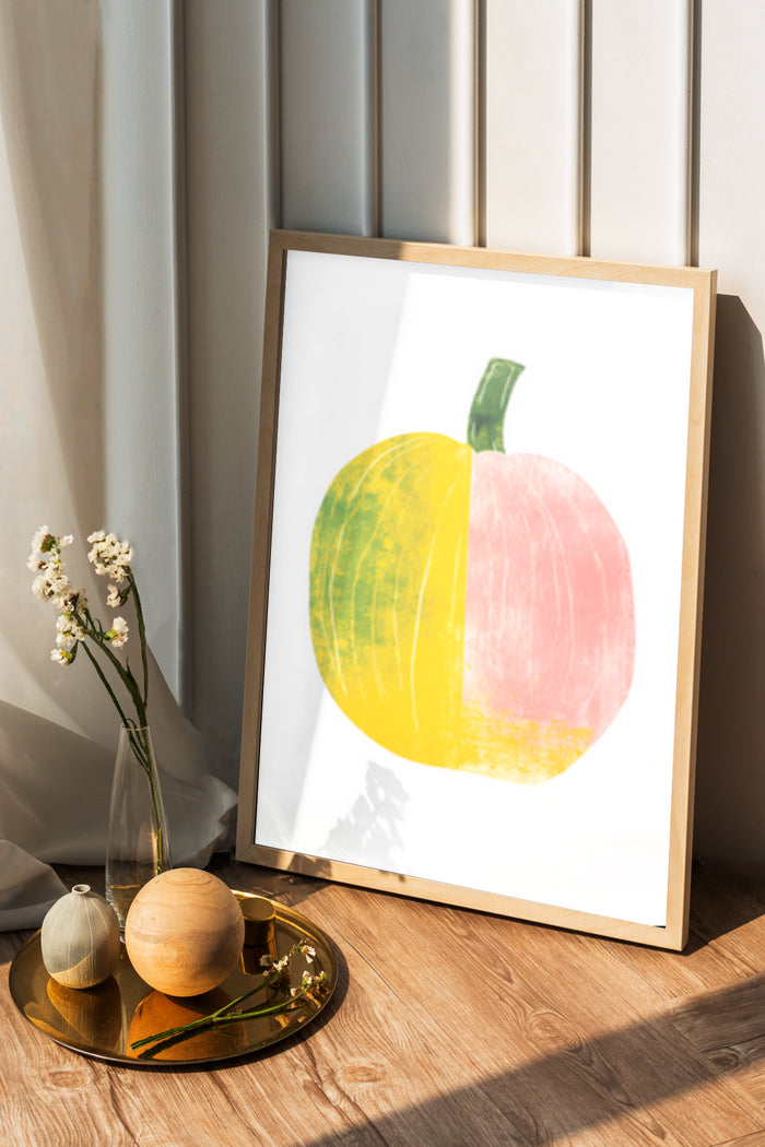 Modern abstract pumpkin artwork in a frame, standing on a wooden floor with decorative items