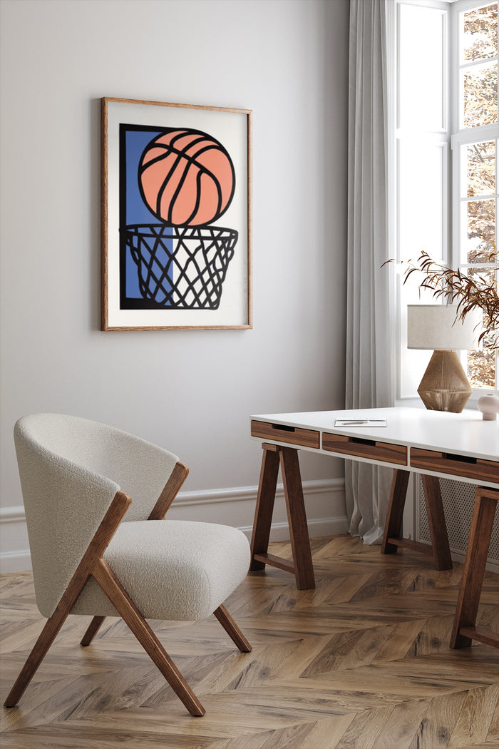 Modern stylized basketball and hoop art poster framed on wall above mid-century modern chair and beside wood desk in a bright home office interior