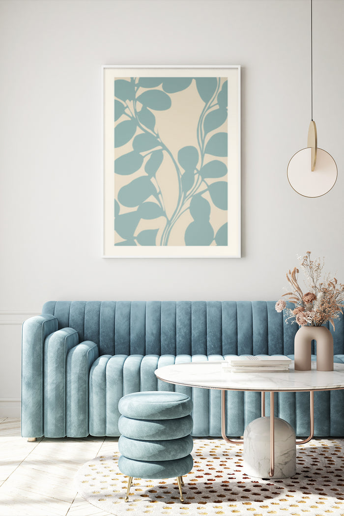 Modern abstract botanical leaf artwork in poster frame above blue velvet sofa in contemporary living room interior