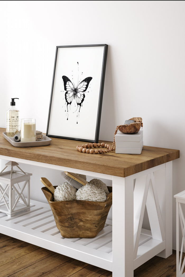 Modern black and white butterfly artwork poster on display in a stylish home interior