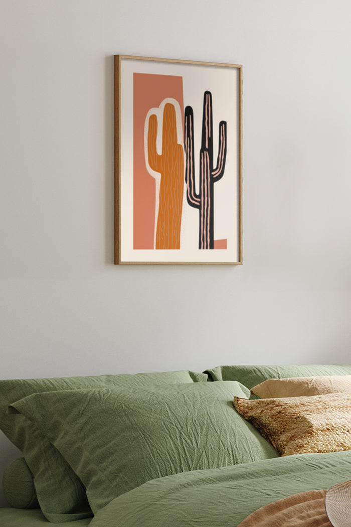 Stylish modern cactus artwork poster framed on bedroom wall above green bedspread