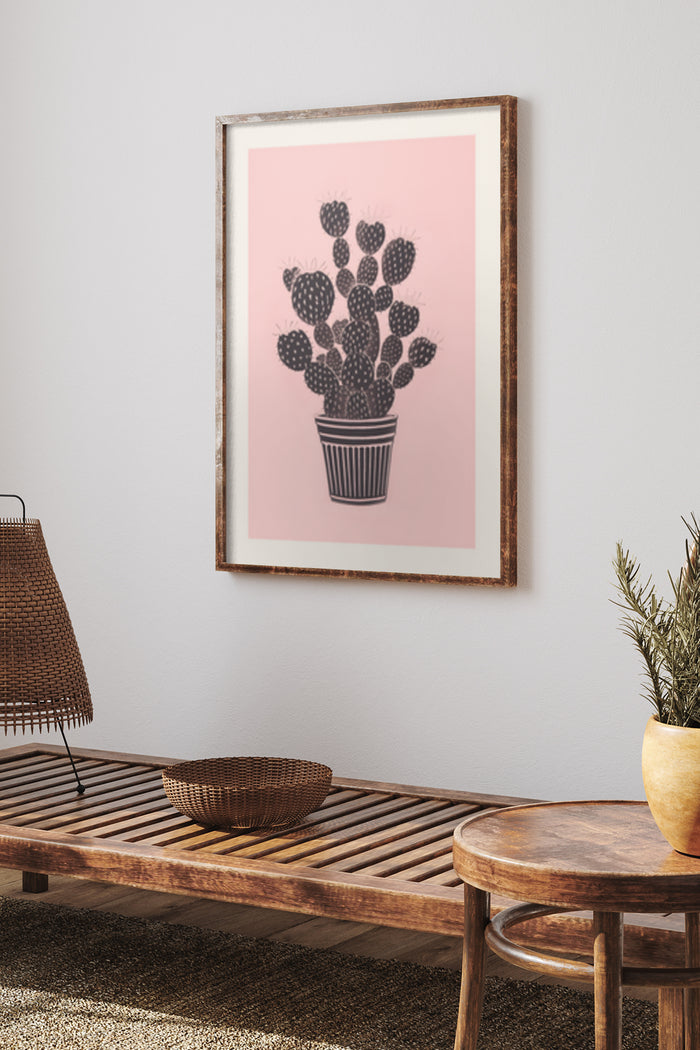Modern black and white cactus illustration in a pink background poster framed and hung on wall