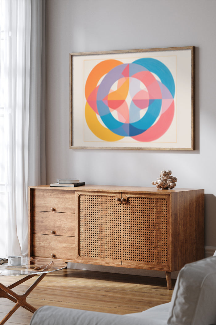 Colorful modern geometric art poster framed on a wall above a stylish wooden sideboard in a contemporary interior
