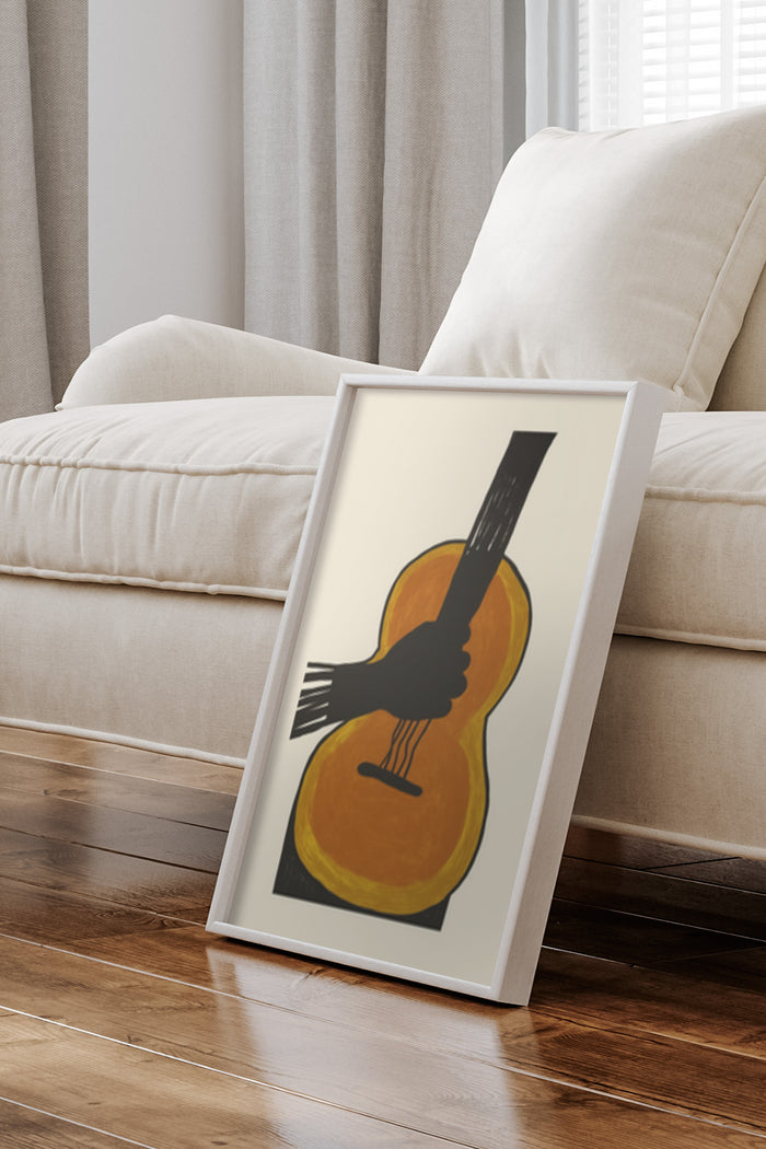 Contemporary art poster of a guitar and a hand in a stylish frame leaning against a wall in a cozy living room interior
