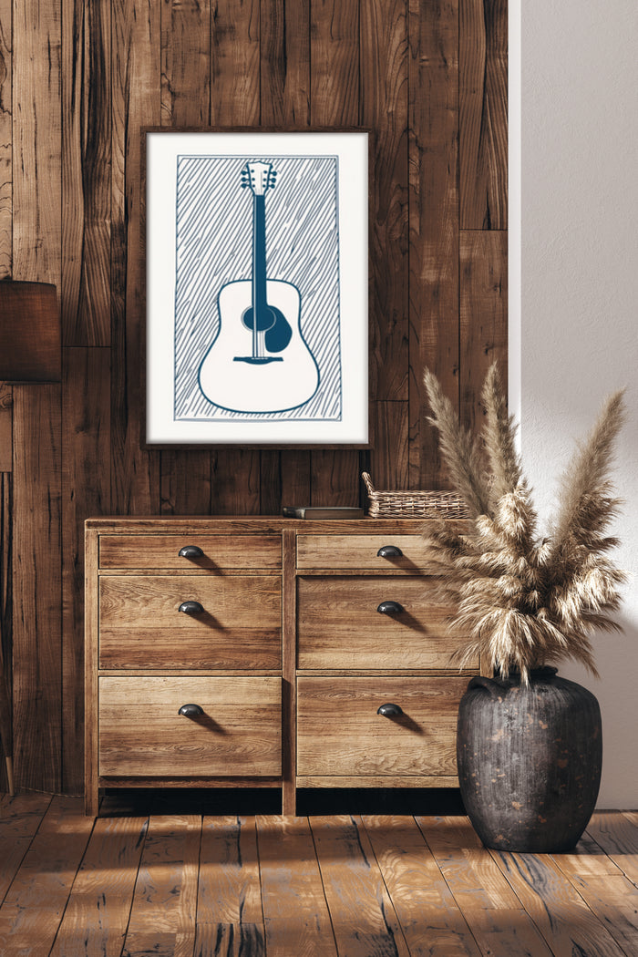 Contemporary blue and white guitar illustration poster framed in a wooden frame on a rustic wall above a wooden cabinet
