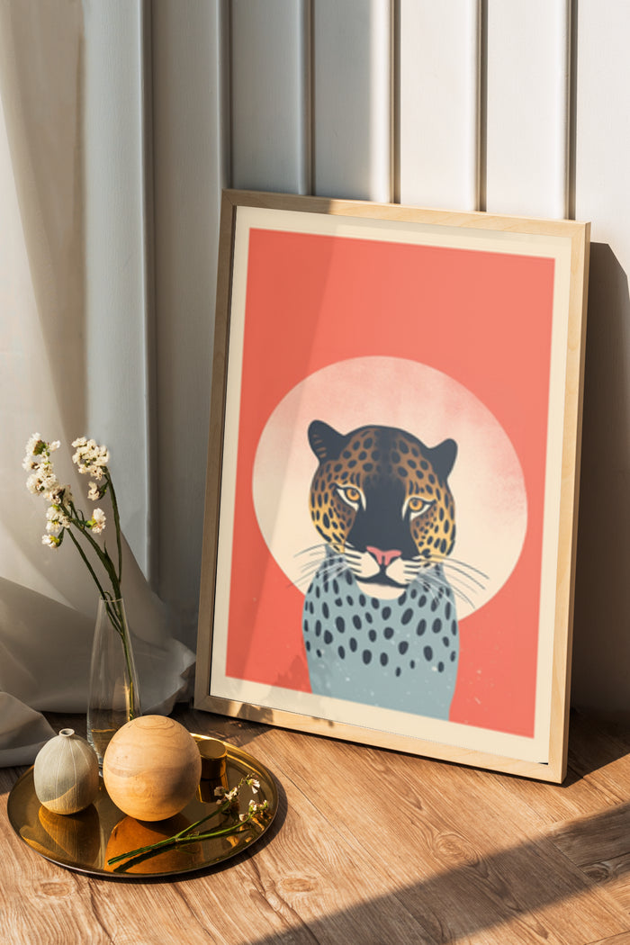 Stylized modern leopard artwork poster framed on a wooden floor with decorative items