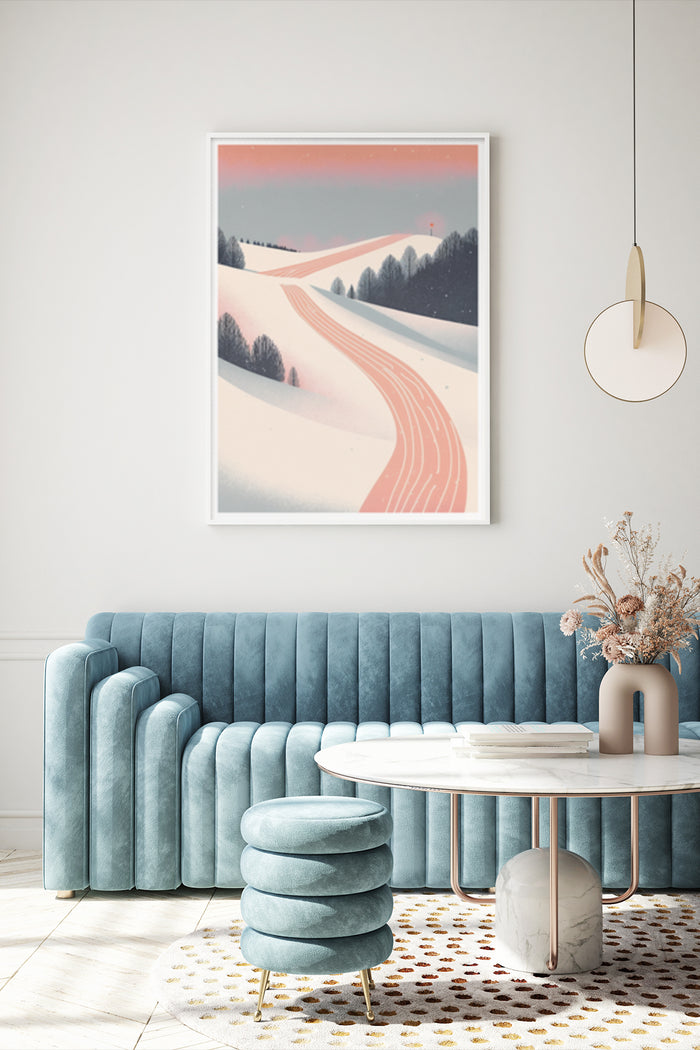 Stylish winter landscape poster with snowy hills and trees against a pink sky, displayed above a teal velvet sofa in a contemporary living room