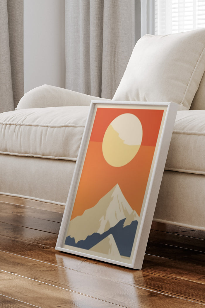 Modern graphic poster of mountain at sunset leaning against wall in living room interior