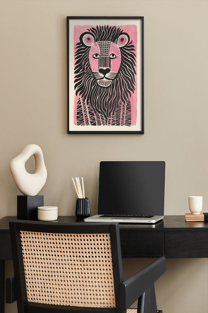 Modern pink and black stylized lion poster framed on home office wall above desk with laptop