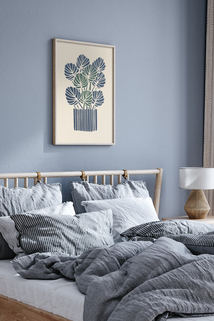 Modern navy blue and white plant artwork poster above bed with gray bedding in contemporary bedroom decor