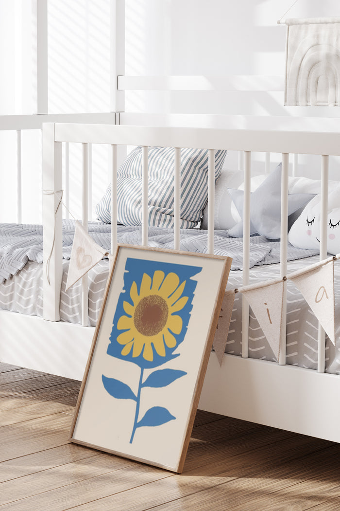 Contemporary sunflower poster leaning against a white crib in a chic nursery setting