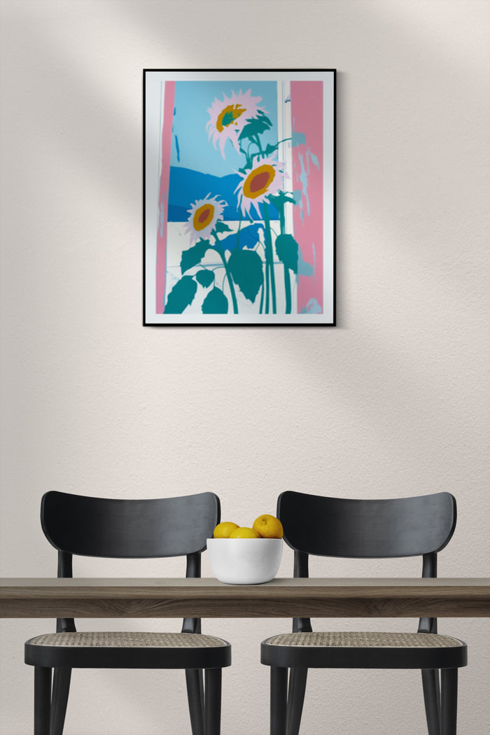 Modern minimalist sunflower artwork poster on a wall above two black chairs and a wooden table with a bowl of lemons