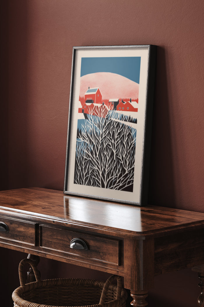 Red barn and winter tree illustration poster art in a frame on a wooden console