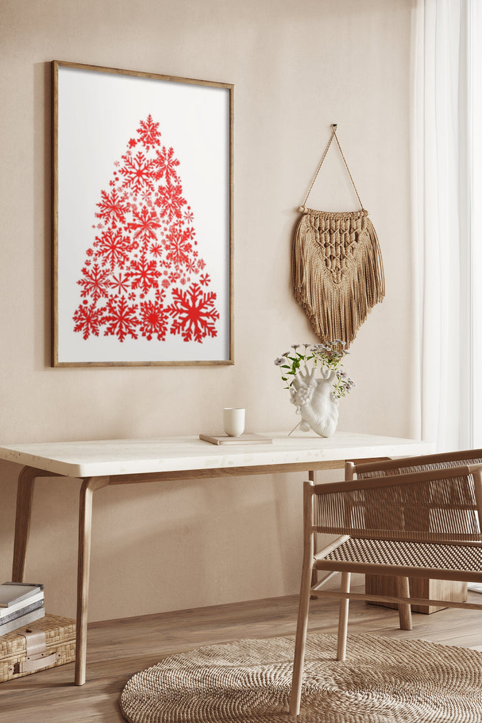 Contemporary red snowflake Christmas tree poster design hanging on a wall above a stylish desk with macrame wall hanging decor