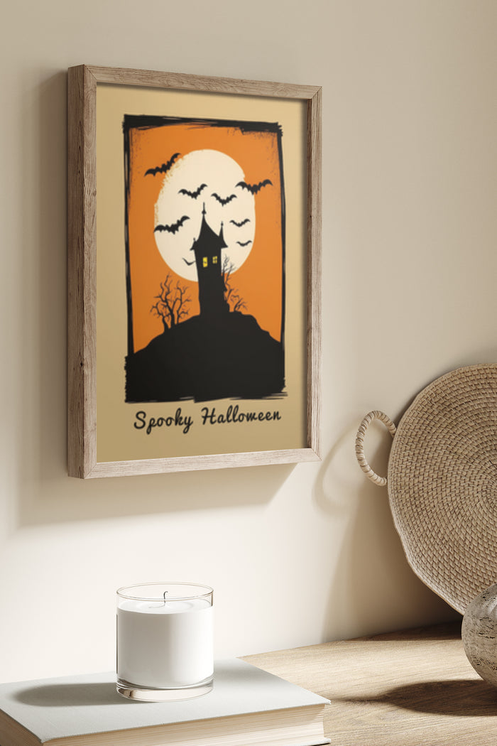 Spooky Halloween poster featuring a haunted house silhouette, full moon, and flying bats, framed and wall-mounted