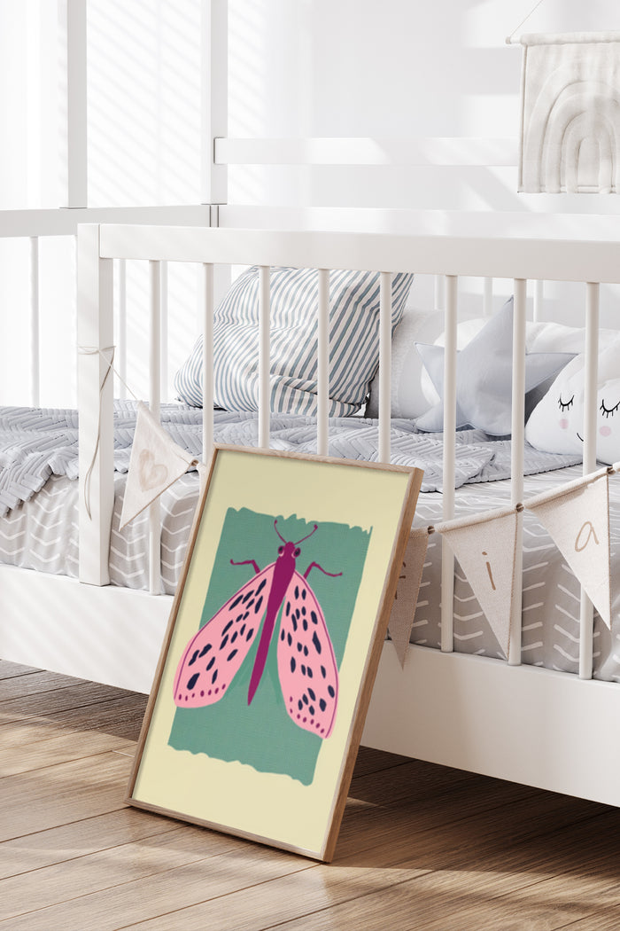 Contemporary colorful moth illustration poster leaning against wall in chic nursery room setting