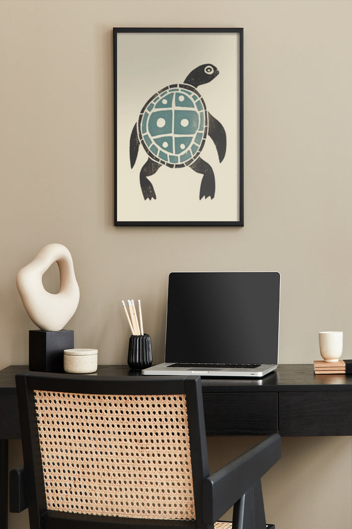 Stylish tribal turtle poster hanging above a home office desk setup with laptop and decorative items