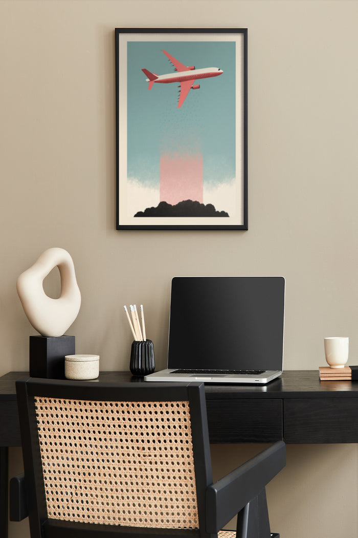 Vintage airplane poster with red aircraft over stylized cloud, displayed above a modern home office desk setup