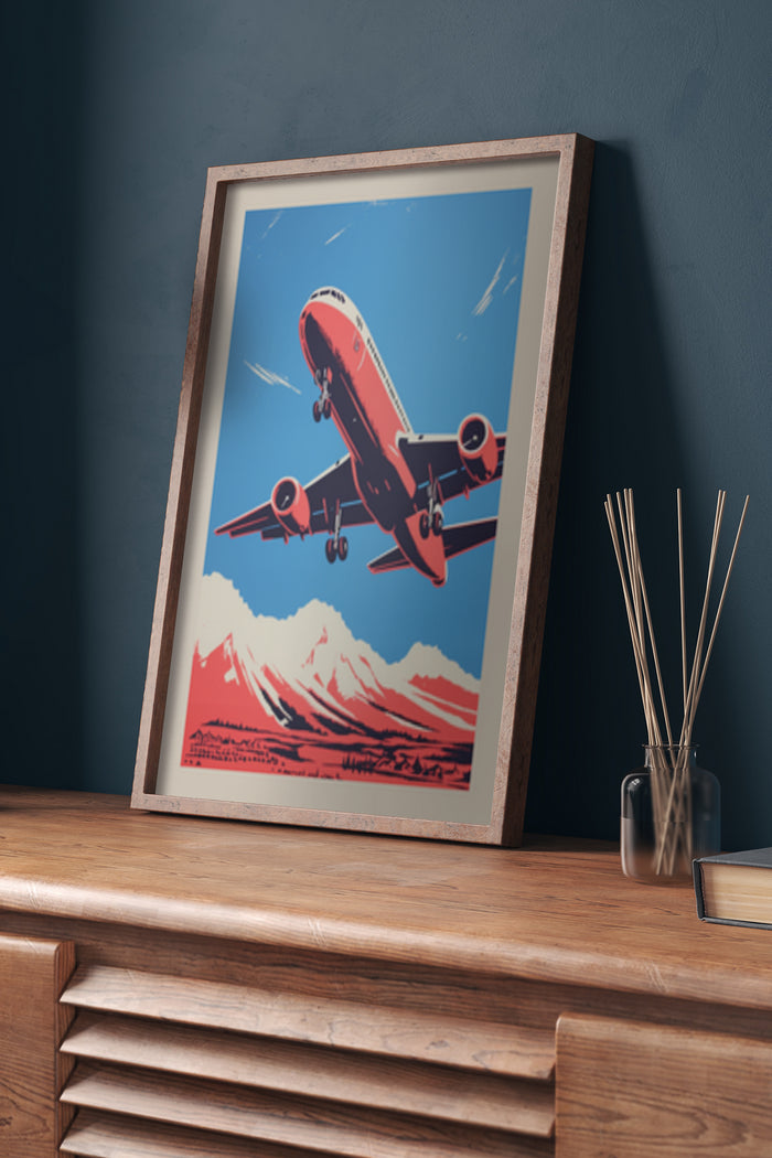 Vintage style poster of a red airplane flying over mountains displayed in a wooden frame