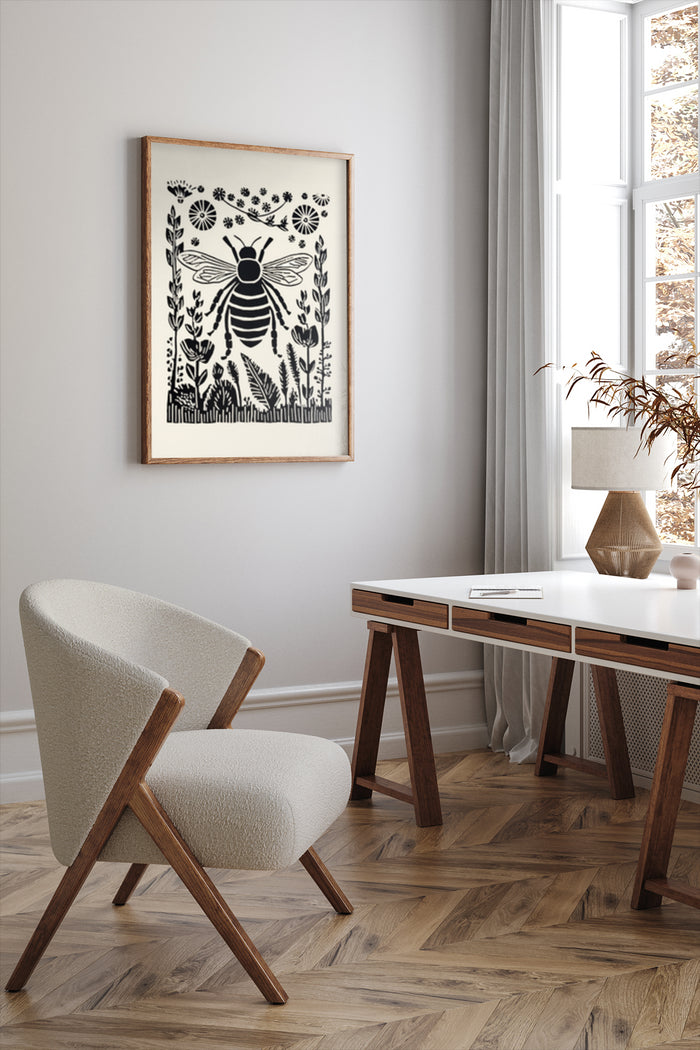 Vintage black and white bee and botanical illustration poster framed in a modern home office with stylish chair