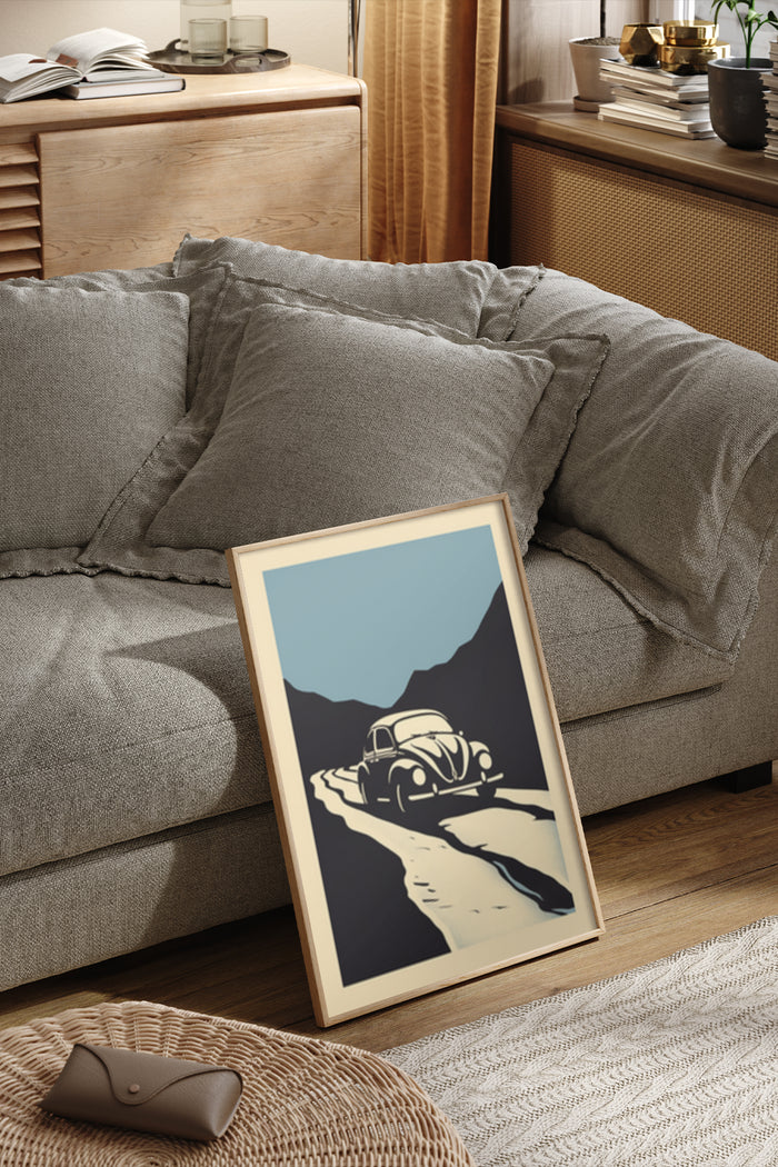 Vintage-style poster featuring a classic car on a desert road framed and displayed in a cozy living room