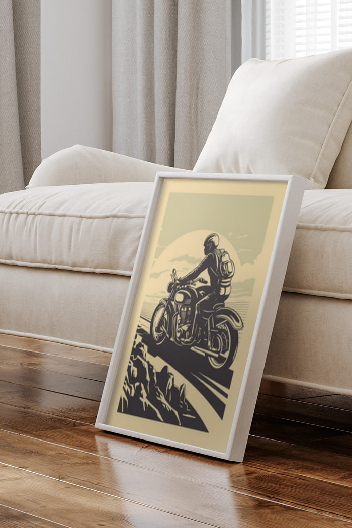 Vintage motorcycle poster artwork in a white frame leaning against a wall in a home setting