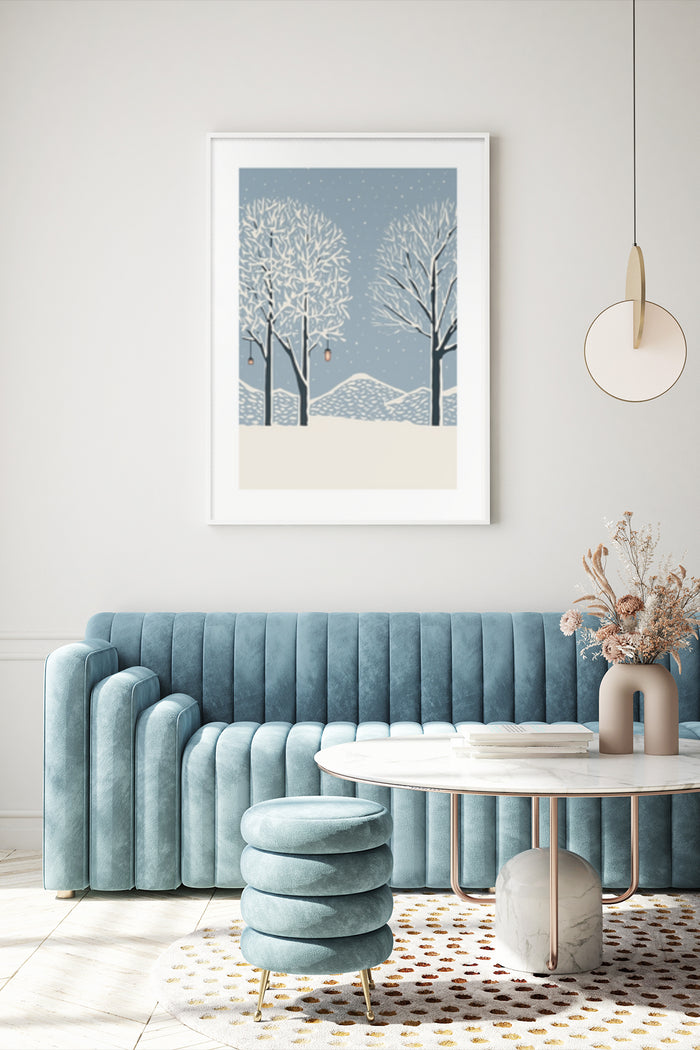 Stylized winter landscape poster with snowy trees and hills hanging above a blue velvet sofa in a modern living room setting