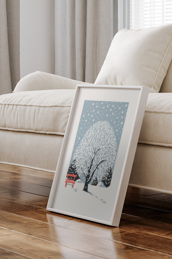Winter scene poster featuring snowy trees and a red bench, leaning against a sofa in a cozy living room